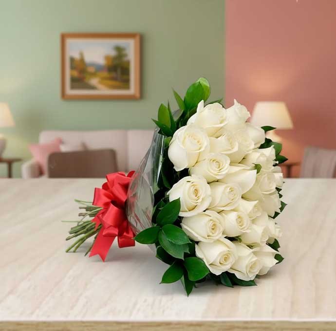 El ramo de 24 rosas blancas con moño rojo es un regalo elegante y lleno de simbolismo. Las rosas blancas representan pureza, sinceridad y respeto, mientras que el detalle del moño rojo aporta un toque de pasión y distinción.