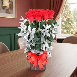 El arreglo navideño con 24 rosas rojas y detalles plateados es un regalo exclusivo y elegante para celebrar la temporada con estilo.